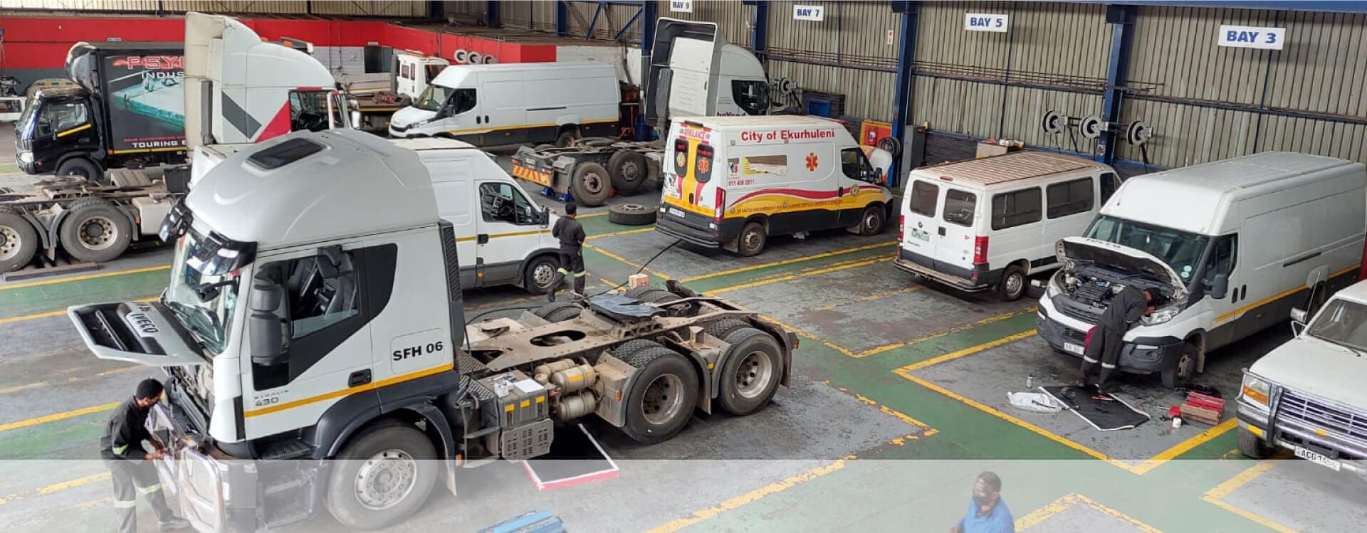 trucks and busses being serviced in workshop